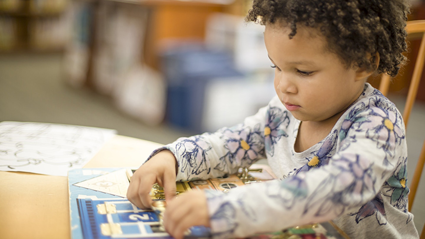 child playing with busy book