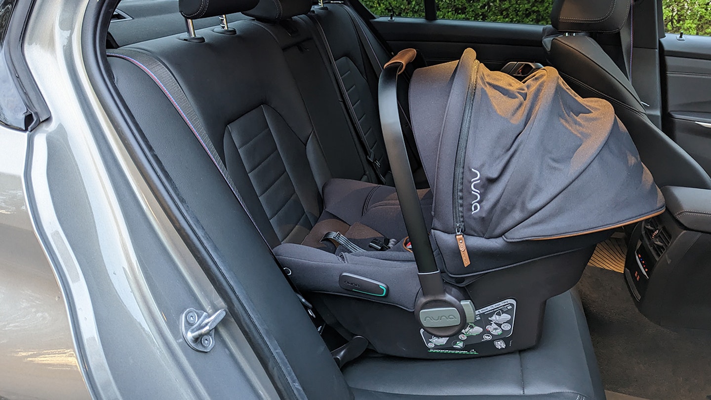 Nuna PIPA urbn car seat facing rearward in the back of a car